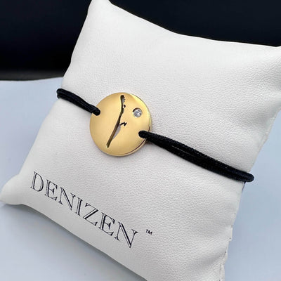 DENIZEN Boca Grande map bracelet in gold-plated stainless steel with black string