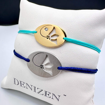 DENIZEN bracelets of stingray silhouette in brushed and gold-plated stainless steel with navy and turquoise string