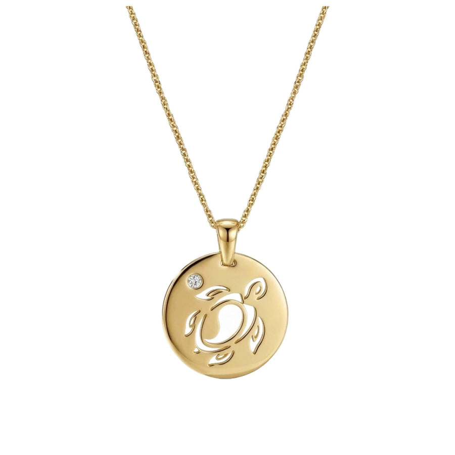 Gold necklace with a round pendant with a sea turtle cutout and a white crystal