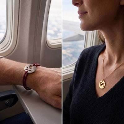 A split-screen lifestyle image showing two jewelry pieces a world map cutout design worn on a man's wrist and a woman's neck while sitting by an airplane window.